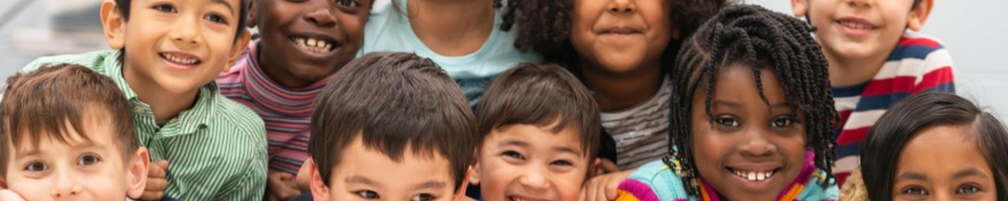 Diverse group of smiling school children.